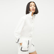 front image of a woman wearing the adina short in white