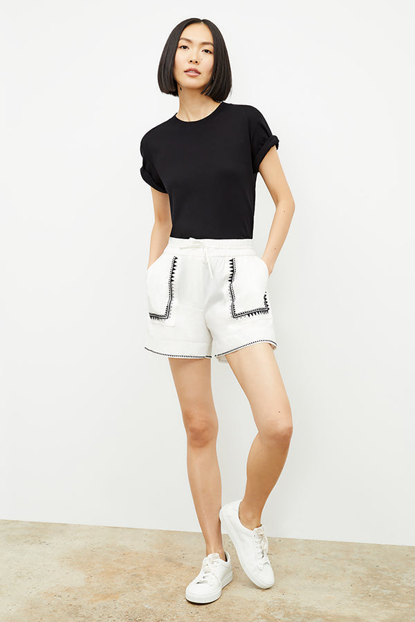 front image of a woman wearing the adina short in white | Exclude