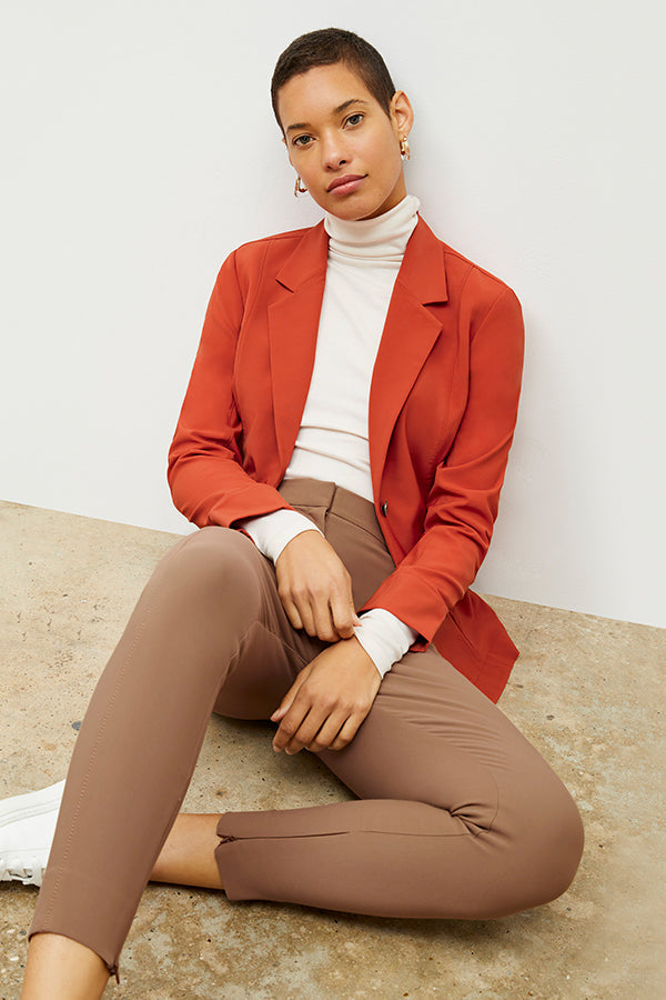 Front image of a woman standing wearing the Curie Pant—Everstretch in Saddle | Exclude