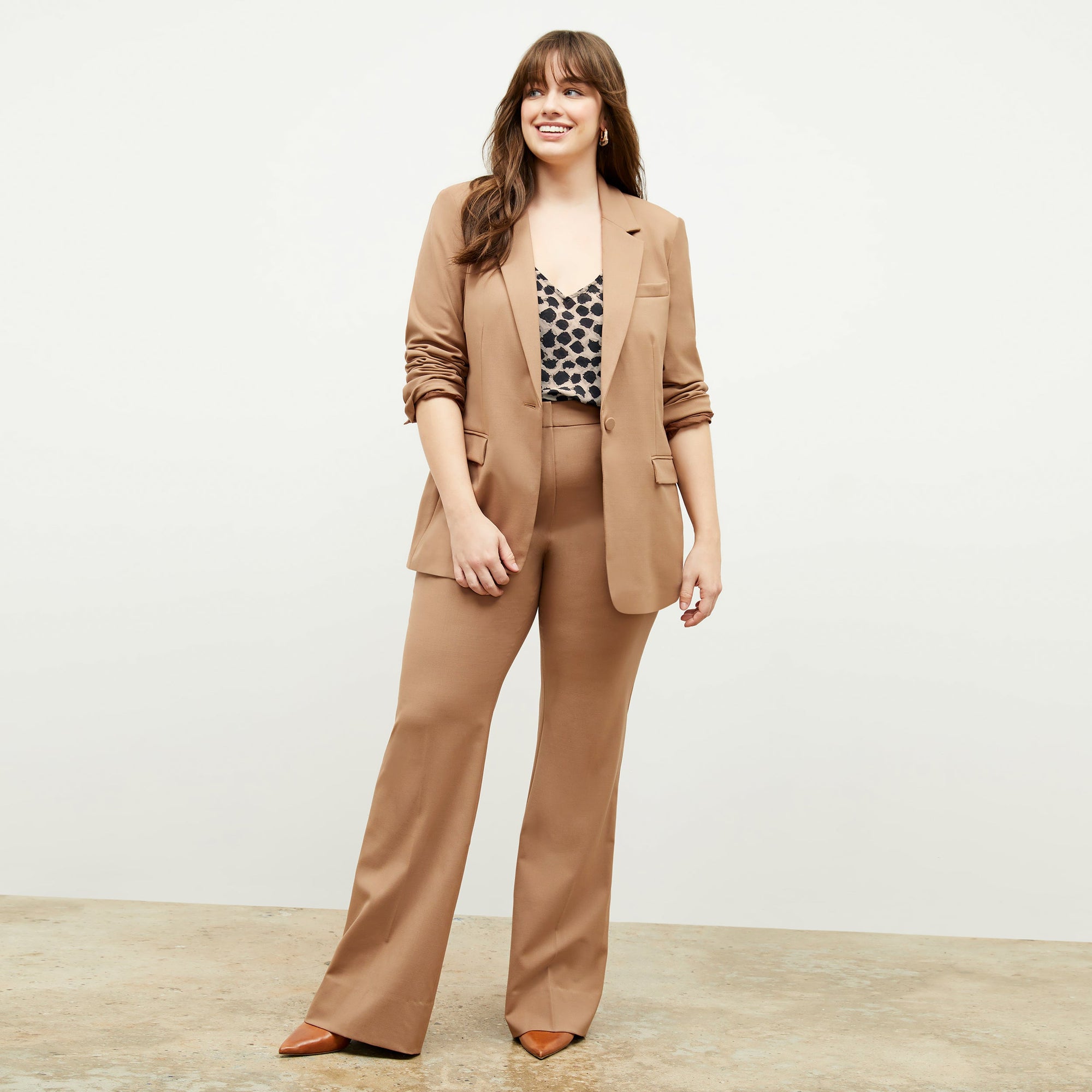 Front image of a woman standing wearing the Lisey Cami—Sahara Print Washable Silk in Tan/Black | Exclude