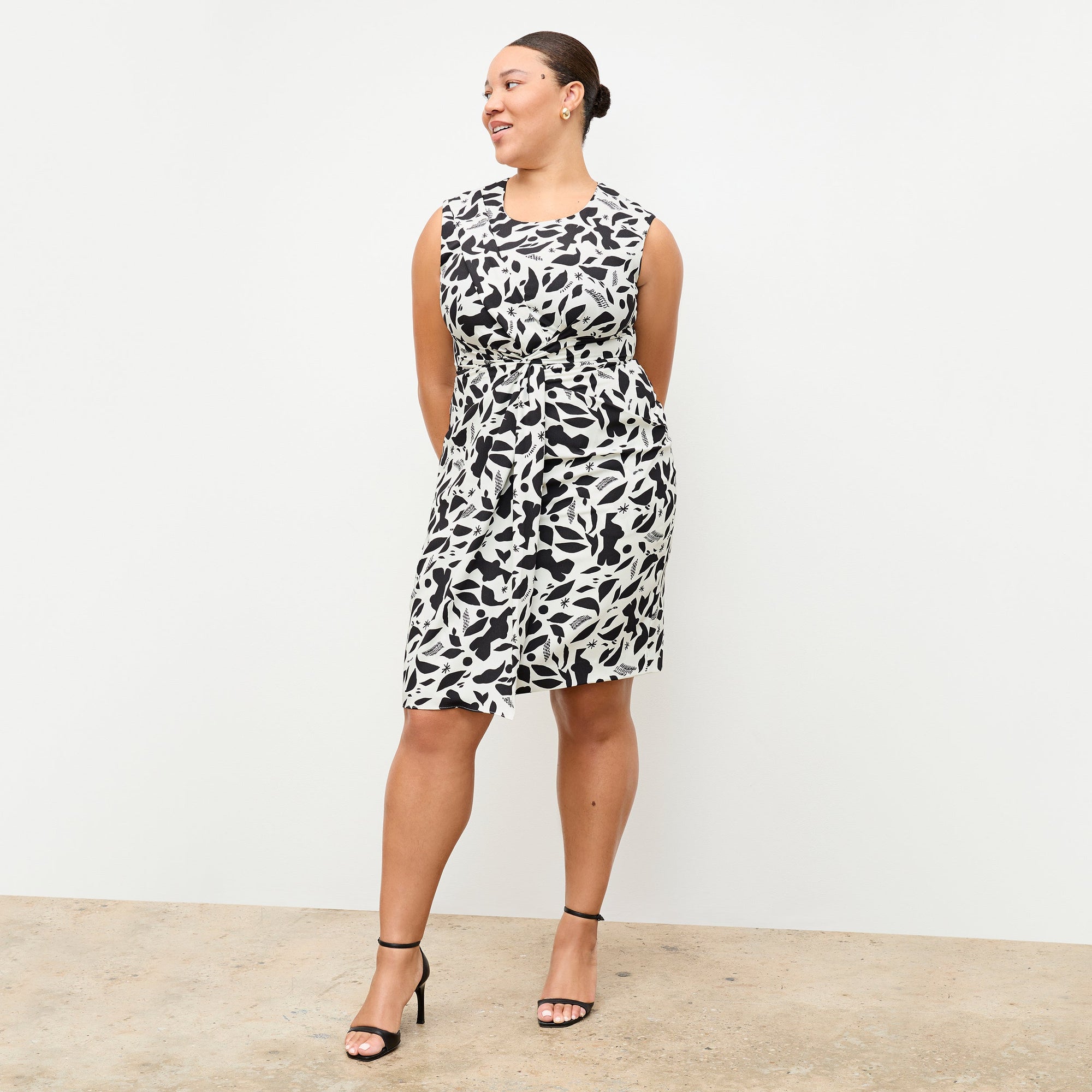 front image of a woman wearing the taylor dress in icon print 