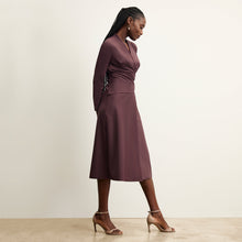 side image of a woman wearing the carly dress in grape