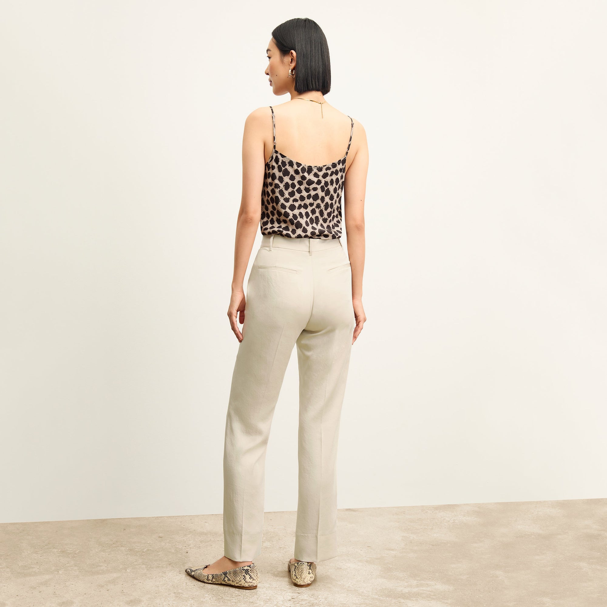 Front image of a woman standing wearing the Lisey Cami—Sahara Print Washable Silk in Tan/Black | Exclude
