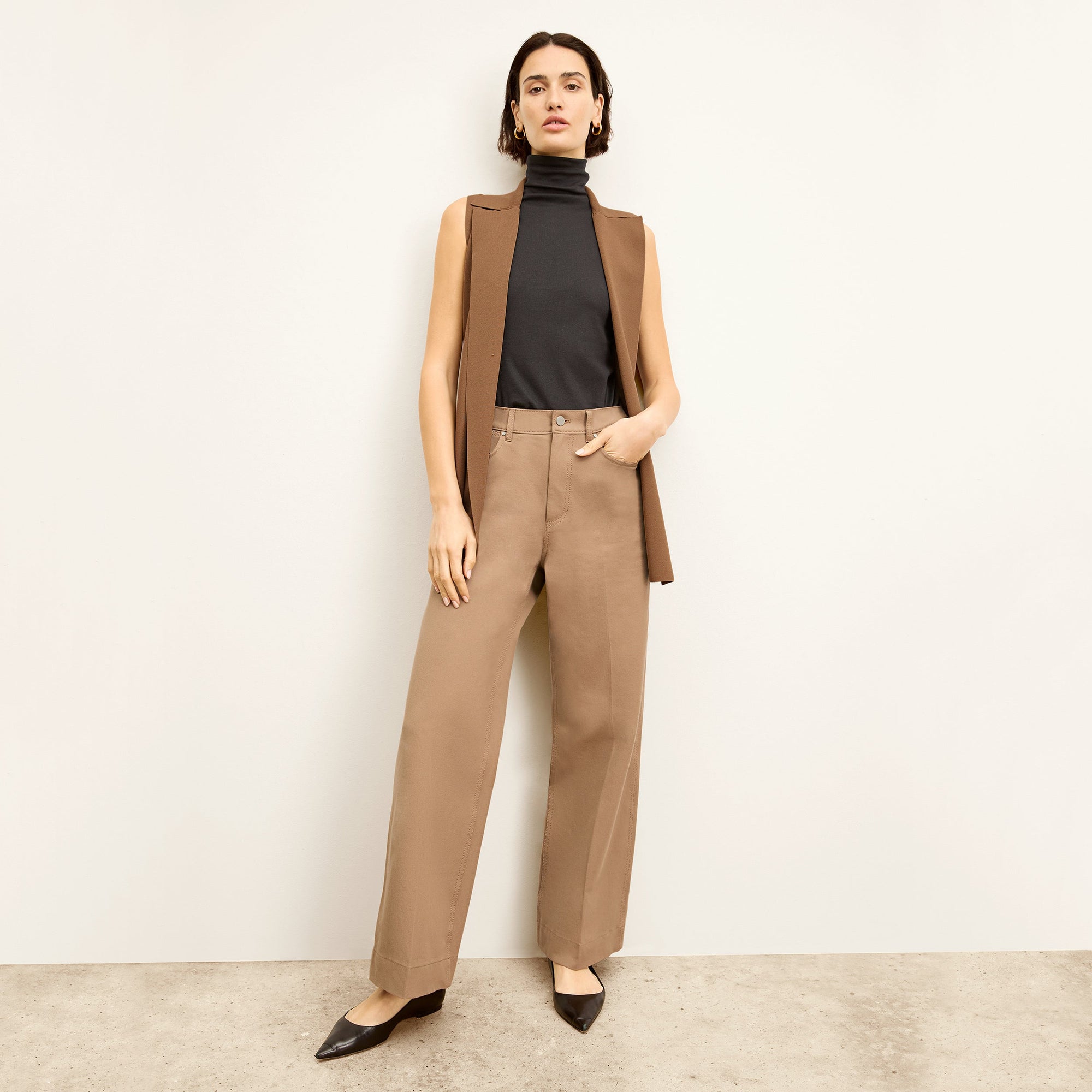front image of a woman wearing the milo jean in saddle | Lead