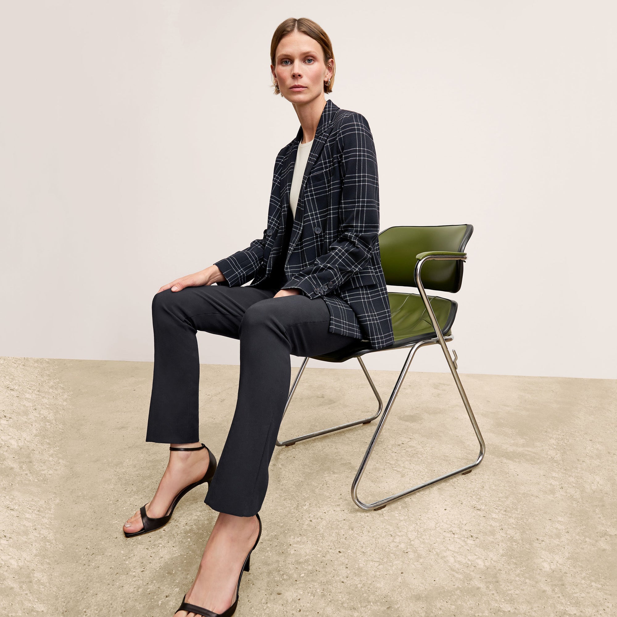 Front image of a woman standing wearing the Foster Pant—Everstretch in Black | Exclude
