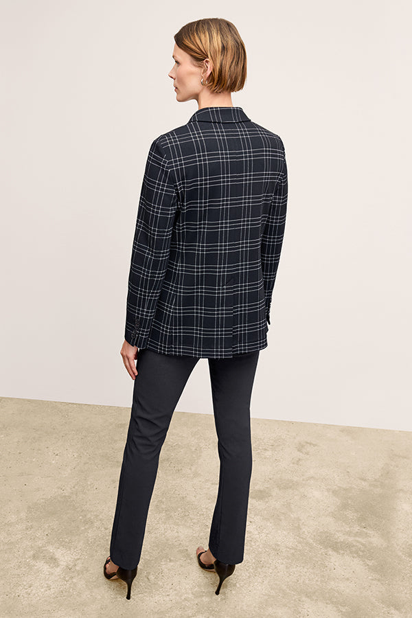 Back image of a woman standing wearing the Foster Pant—Everstretch in Black | Exclude