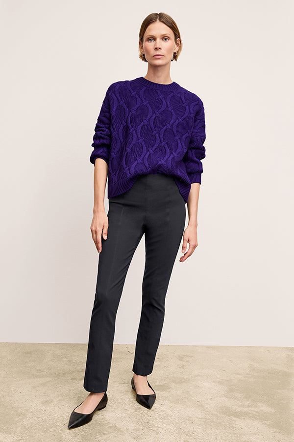 Front image of a woman standing wearing the Foster Pant—Everstretch in Black | Exclude
