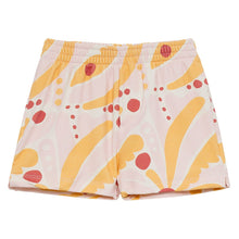 Pink and yellow swim trunks with red circular and curved palm leaf print design.