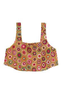 Tan silk crop top with colorful floral print in red, orange, pink, and green, featuring a square neckline and wide straps.