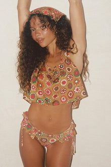 Tan silk crop top with red, pink, and green floral pattern and square neckline on model.