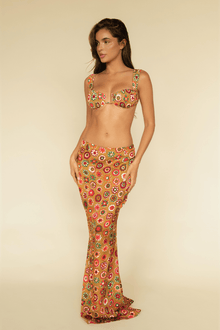 Maxi skirt in tan silk with multicolored floral circle pattern, fitted at hip with flared hem.