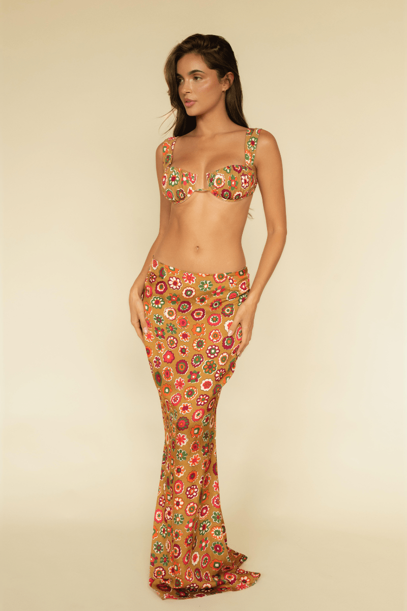 Maxi skirt in tan silk with multicolored floral circle pattern, fitted at hip with flared hem.