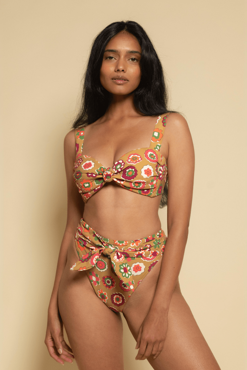 Floral tie-up bikini bottom in red, yellow, and green with multicolored flower print and side tie closures.