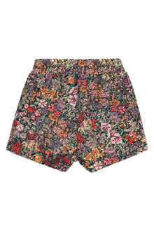 Dark swim trunks with multicolored floral print featuring orange, pink, red, and purple flowers on green foliage background.