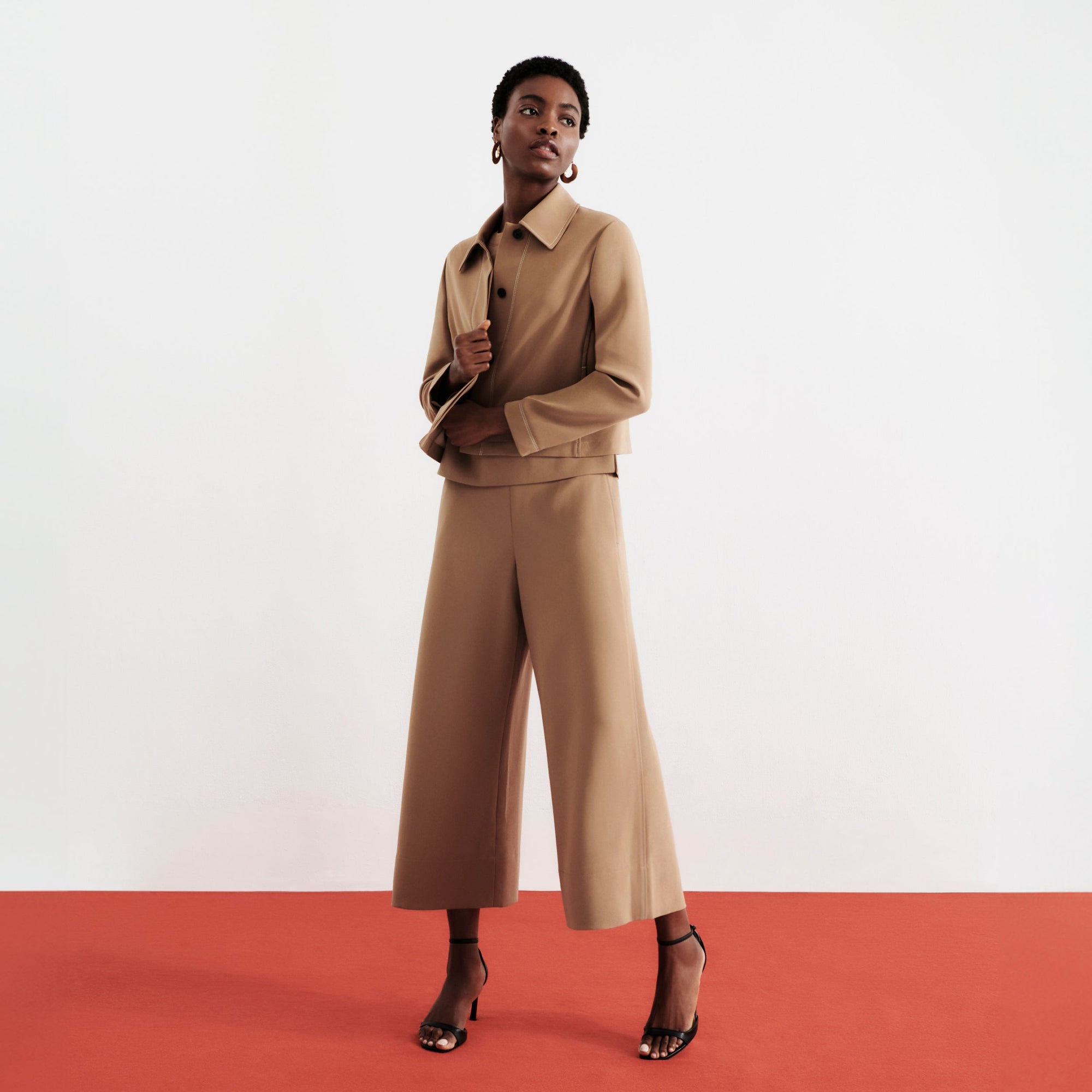 front image of a woman wearing the nicky jacket in saddle