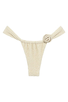 Oat textured bikini bottom with side tie straps and decorative rosette buckle detail.