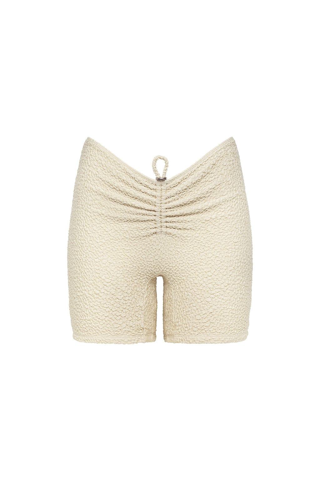 Oat-colored textured shorts with ruched detailing at center back and drawstring waistband.
