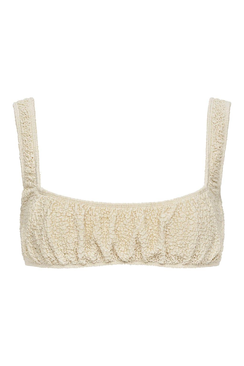 Oat-colored textured sport top with wide shoulder straps and ruched front detail.