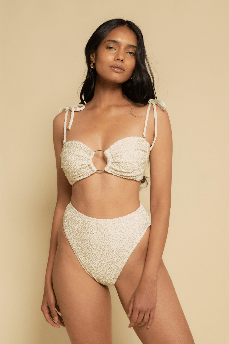 Oat-colored textured bandeau bikini top with tie shoulders and center ring detail.
