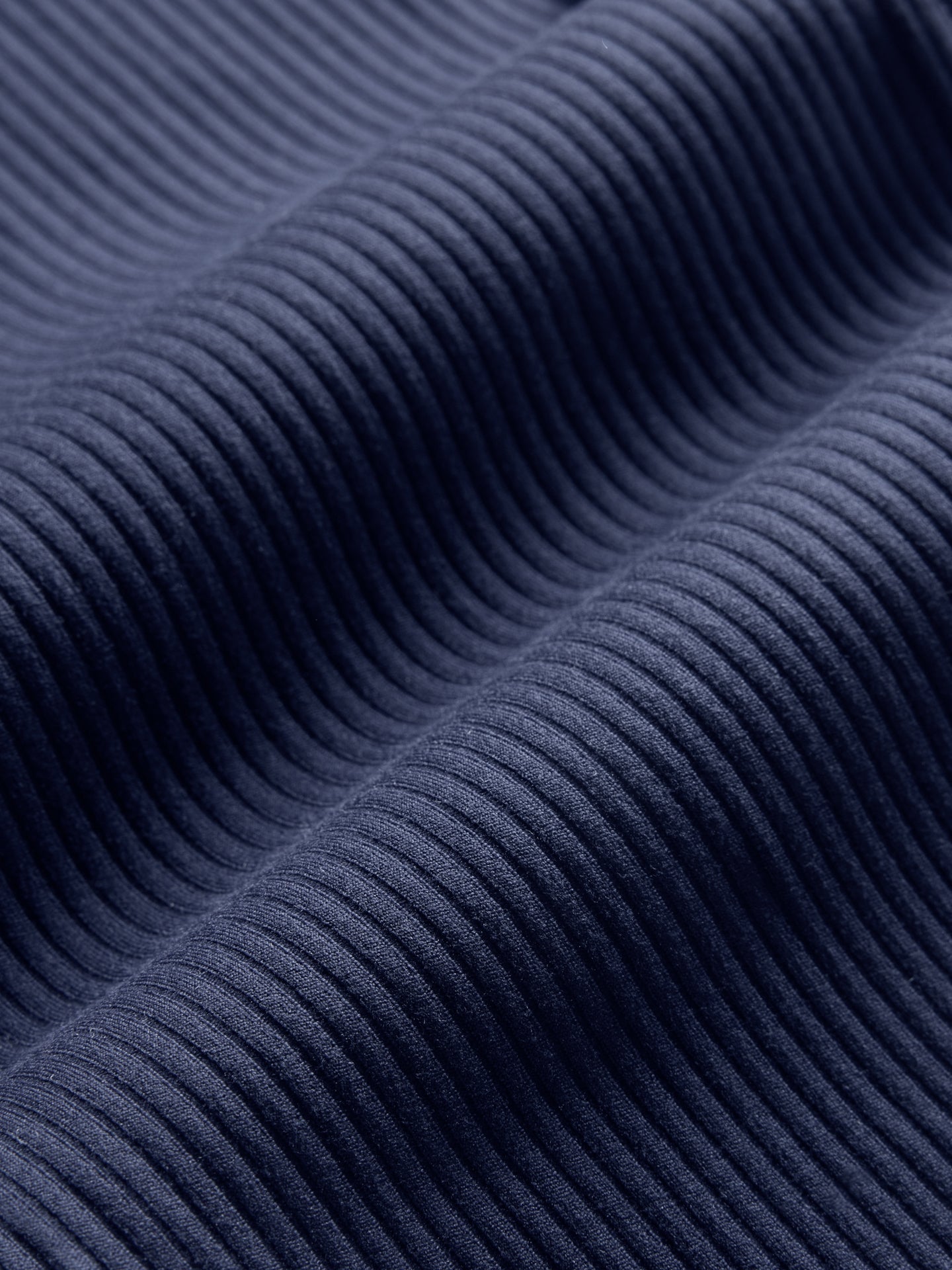 Close-up of ribbed Melt fabric texture in true navy.