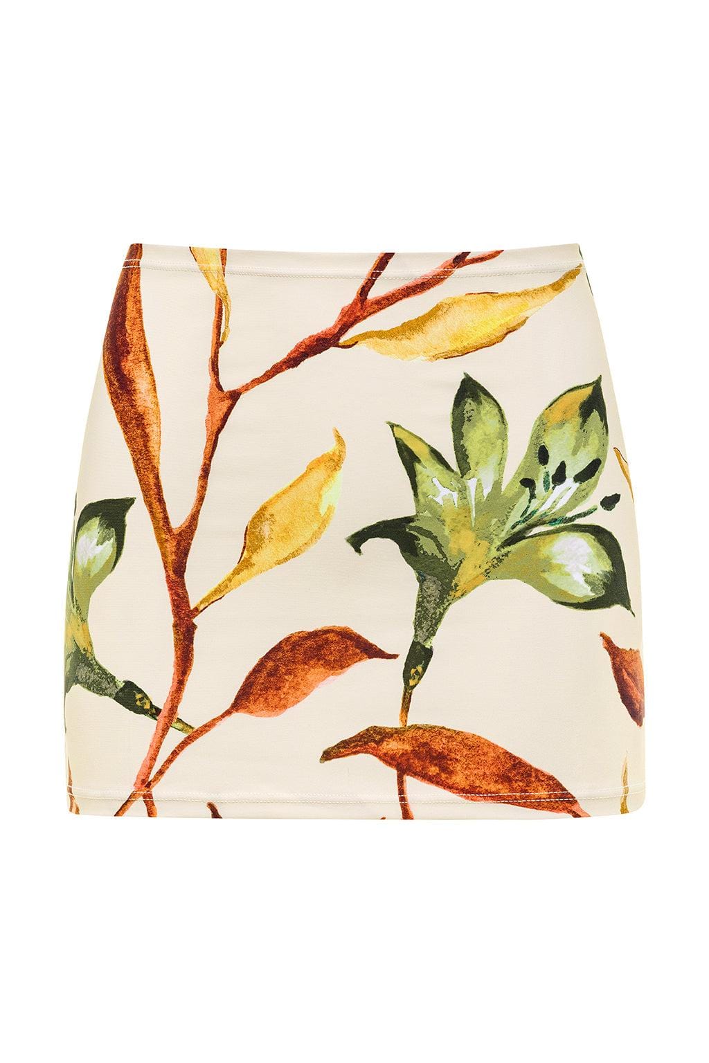 Cream mini skirt with botanical print featuring rust, yellow, and green branches and leaves.