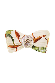 Bandeau bikini top with floral print featuring red and orange flowers on cream fabric, centered with a decorative rose-shaped