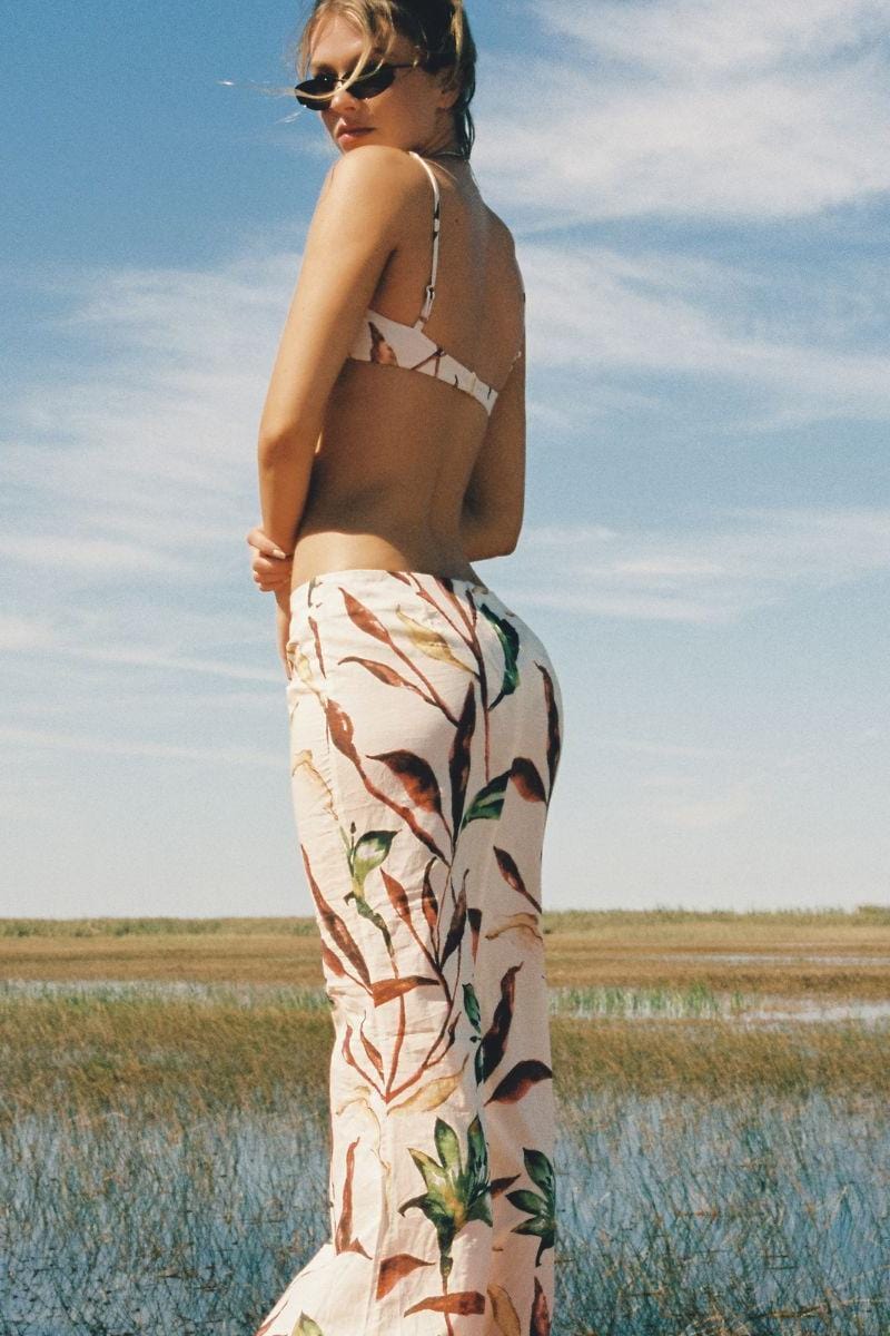 Cream-colored skirt with multicolored floral leaf print worn with brown crop top.