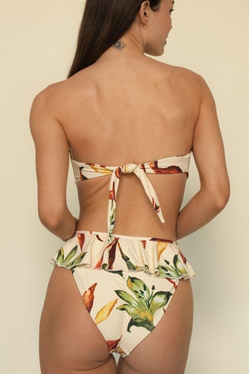 Cream bikini bottom with tamarindo floral print and ruffled waistband, shown from back view.