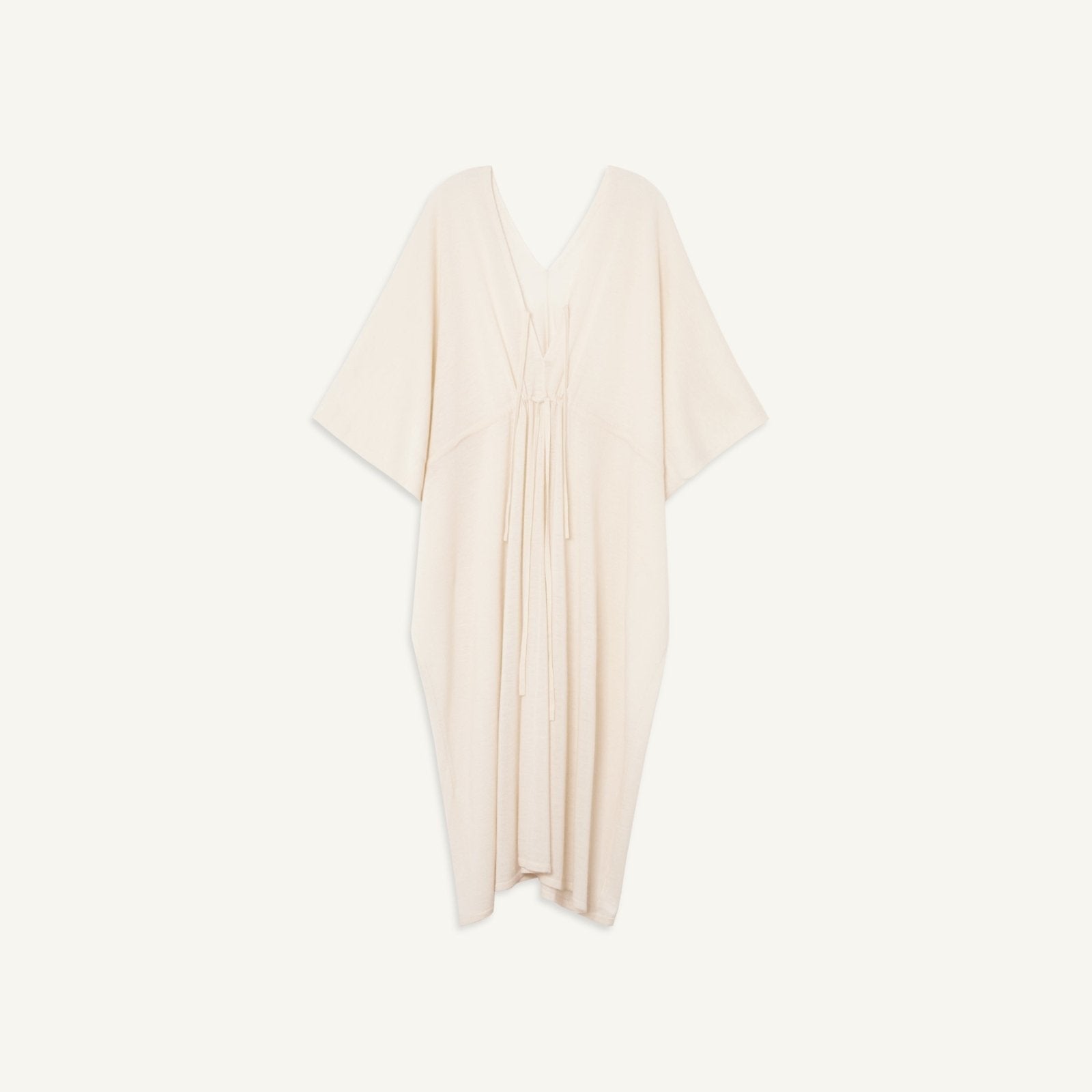 Lightweight cream-colored cashmere kaftan with adjustable waistline tie and V-neck with keyhole tie detail.