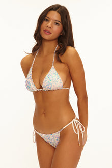 Woman wearing a floral bikini on a white background