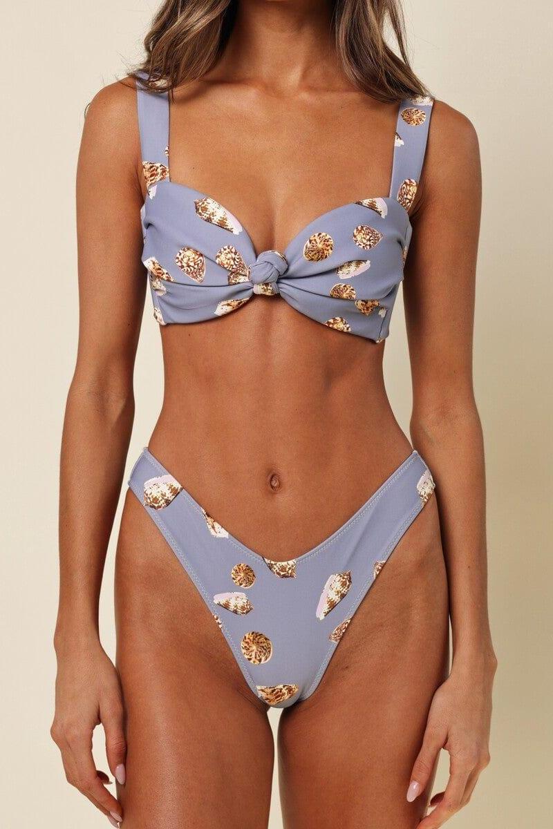 Lavender bikini bottom with gold shell pattern and zig-zag stitched edges on model.