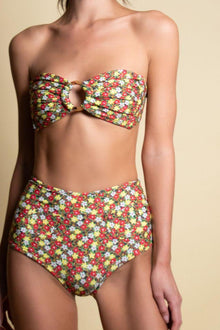 High-waisted bikini bottom with multicolored floral print in red, yellow, white, and green on dark background.