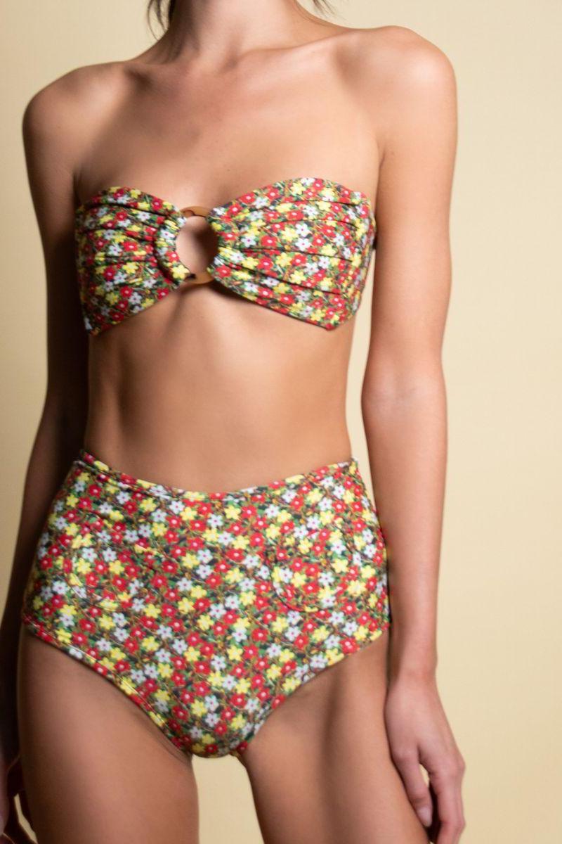 High-waisted bikini bottom with multicolored floral print in red, yellow, white, and green on dark background.