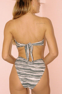 Striped bandeau bikini top with tie-back closure in cream and gray.