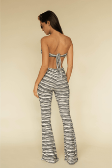 Black and white striped flared legging with textured knit fabric, shown from back view on model.