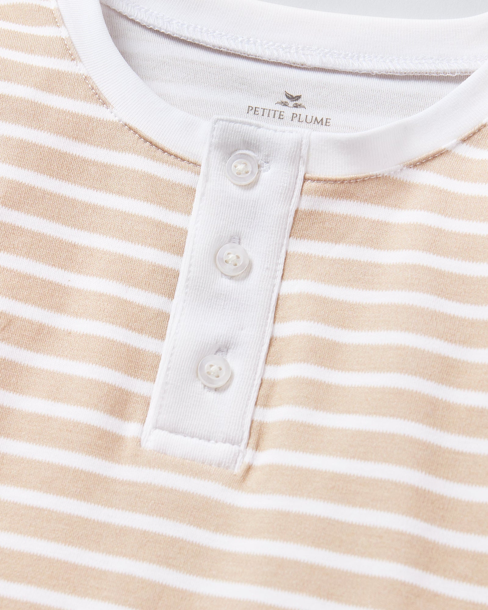 Kid's Pima Snug Fit Pajama Set in Camel Stripe features a beige and white striped long-sleeve top with white cuffs and button placket, plus matching pants with white ankle cuffs.
