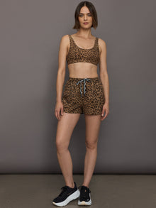 Model wears scoop neck sports bra with animal print, wide shoulder straps and a supportive fit.