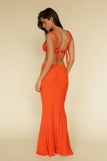 Tangerine textured maxi skirt with high waist and flared hem, shown from back on model wearing matching crop top.
