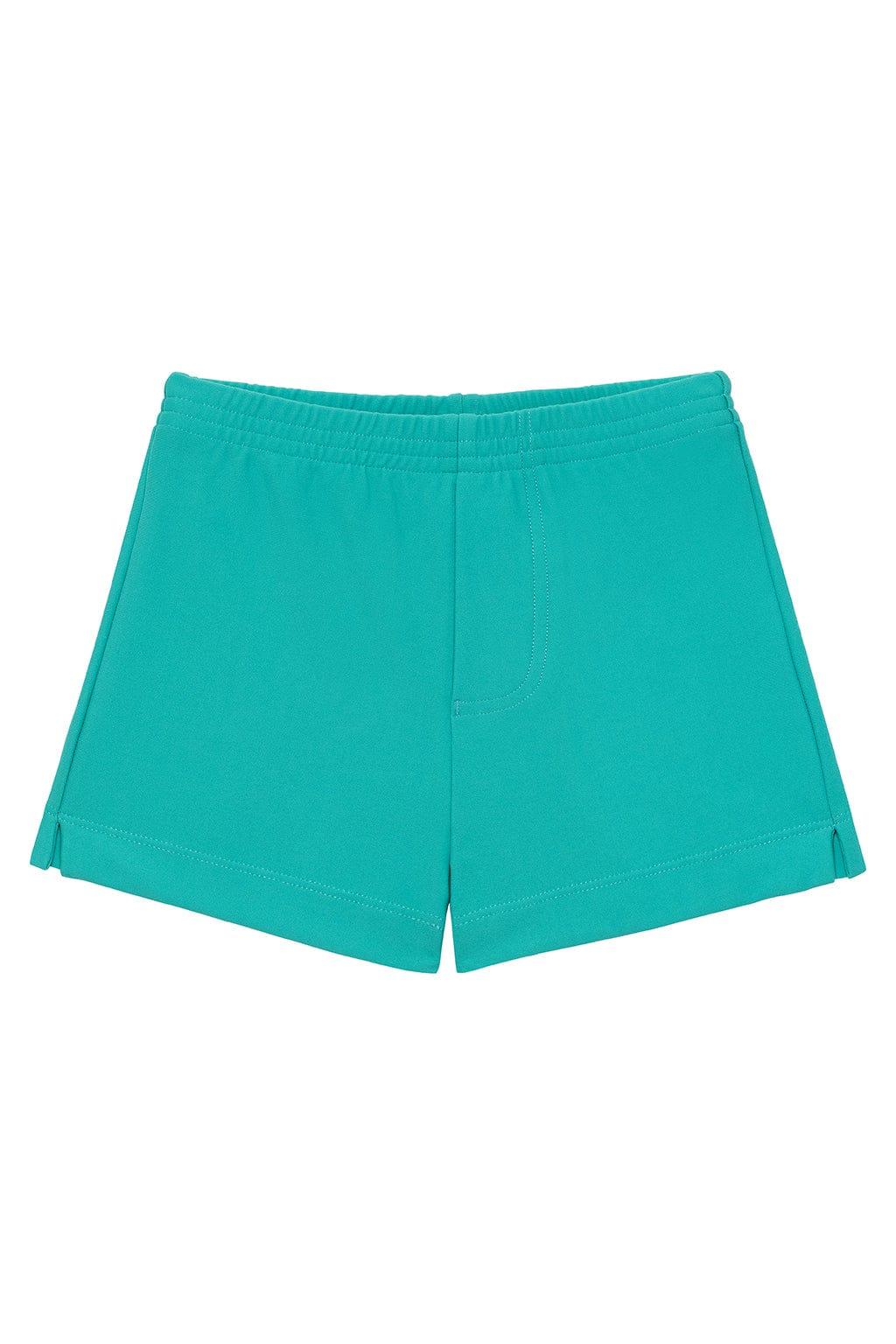Teal mini swim trunk with elastic waistband and side vents, laid flat on white background.
