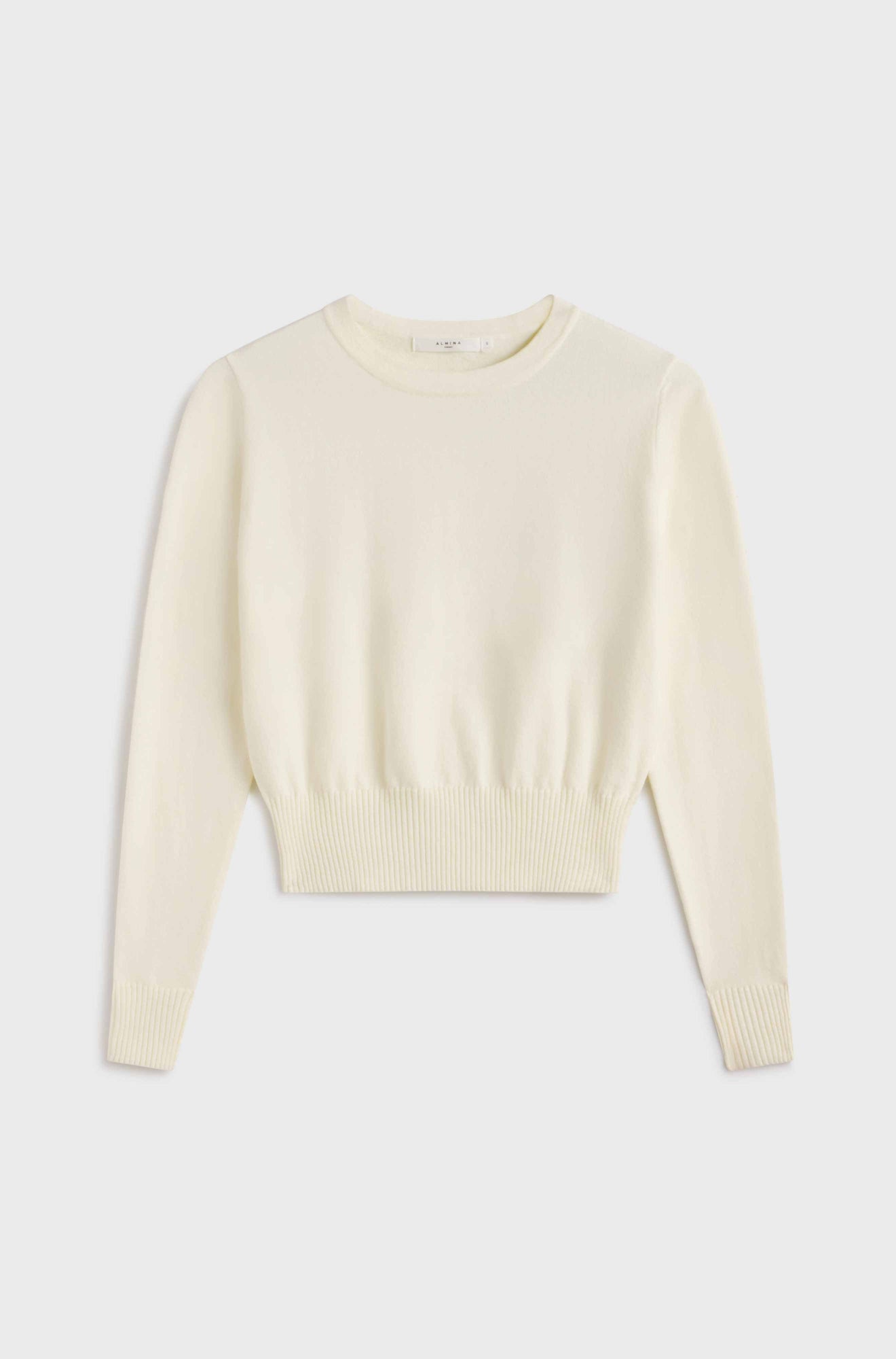Cream-colored sweater on a light gray background