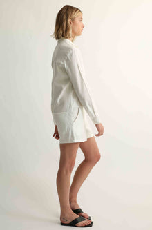 Woman wearing a white linen jumpsuit