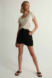 Woman wearing a tee shirt and black shorts