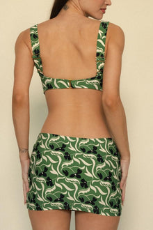 Green and cream floral print micro skirt with black flower embellishments and matching bikini top.