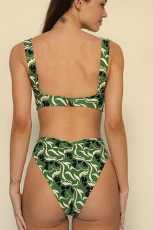 Green and cream floral print bikini bottom with black accents, shown from back view.