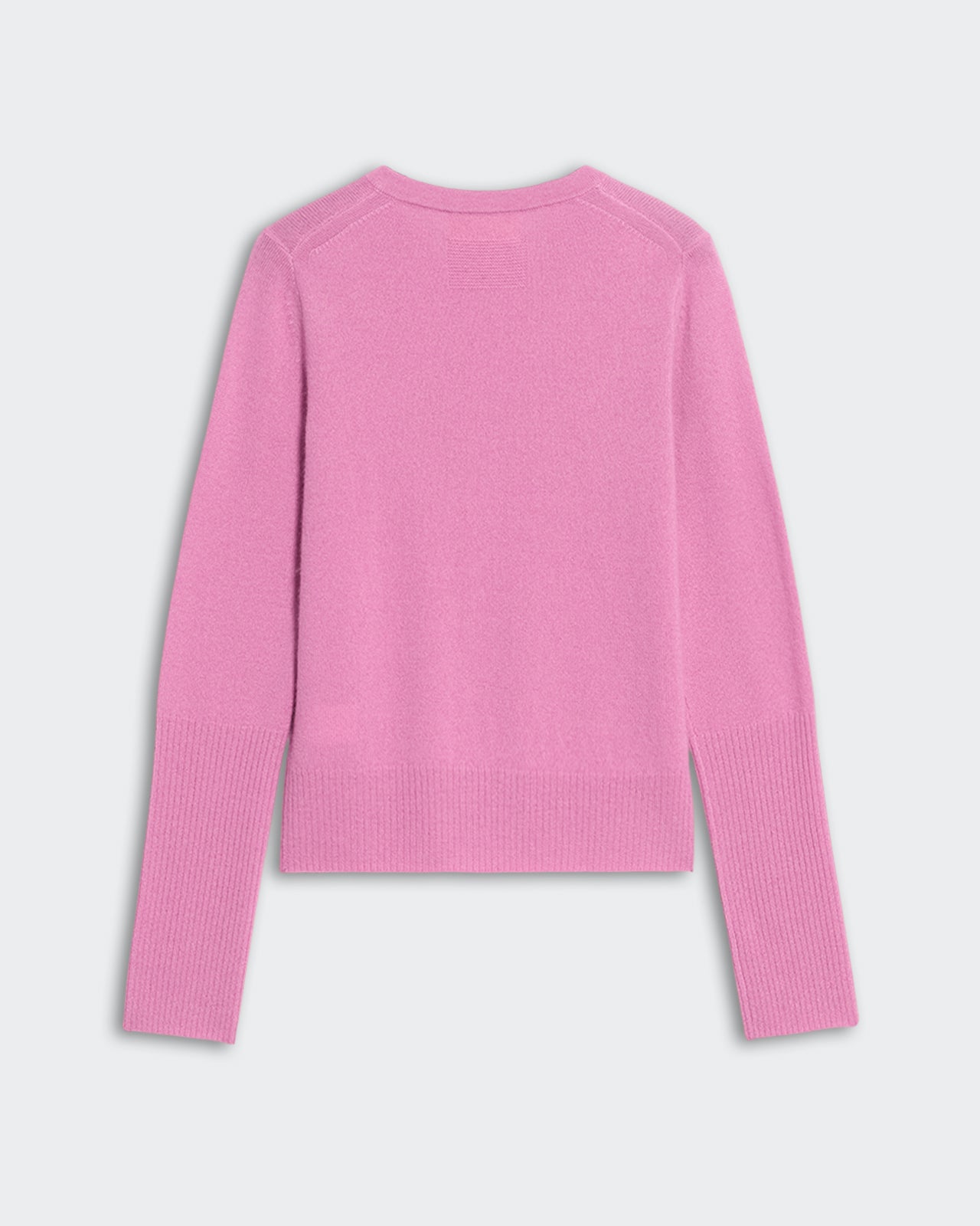 Back view of lightweight rose pink cashmere Jane Cardigan with ribbed hem and cuffs on grey background