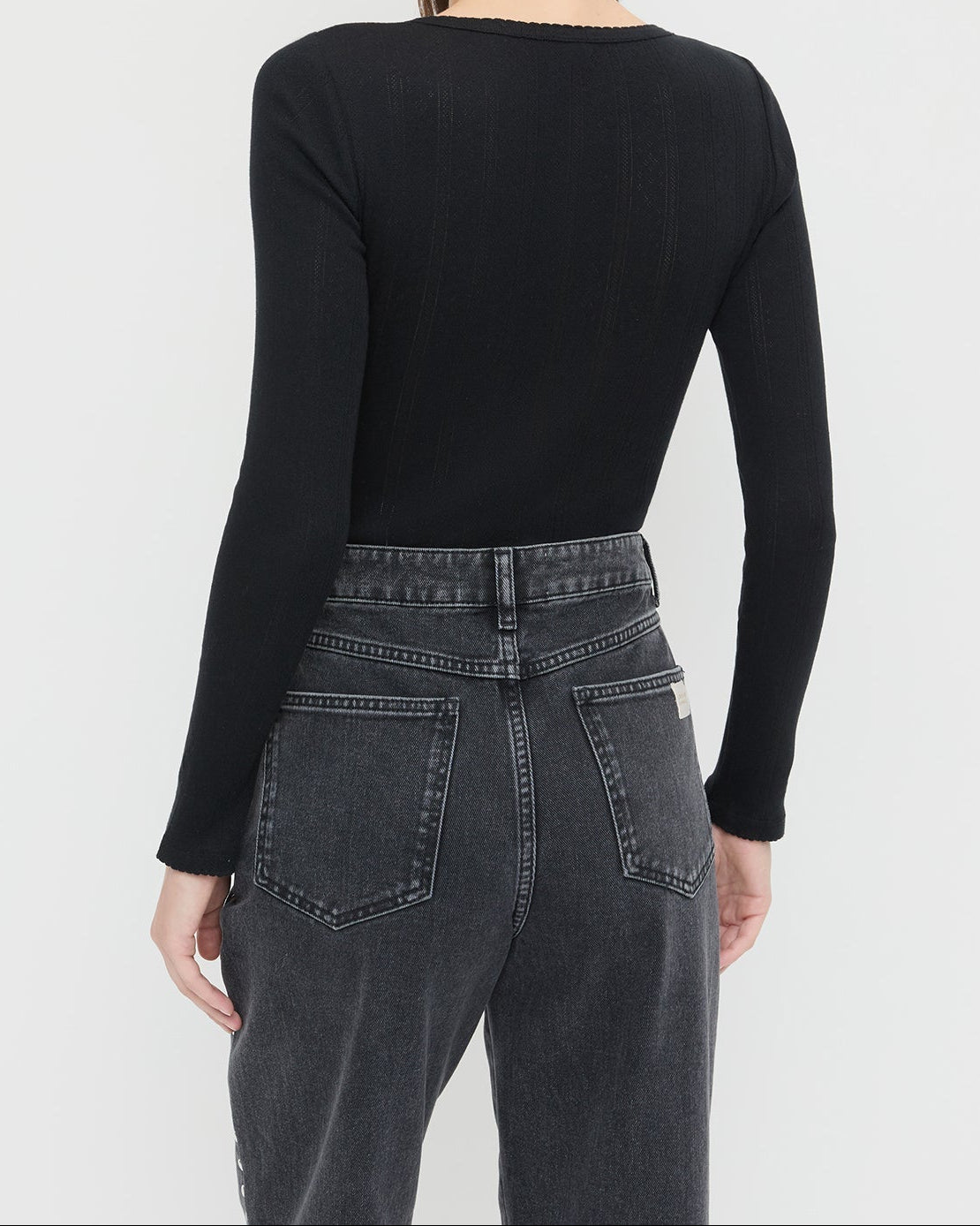 Kaya Pointelle Long-Sleeve Bodysuit in black and Winona Denim Barrel Pant in washed black.
