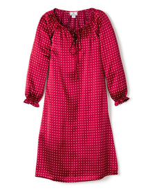 The Girls Silk Delphine Nightgown by Petite Plume in a Bordeaux polka dot design is perfect for cozy sleepwear. It features a gathered neckline with tie detail, slightly ruffled sleeve cuffs, and a relaxed straight cut that falls gracefully below the knees, combining elegance with comfort.