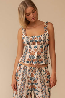Sleeveless square-neck tank top with orange and teal floral print on cream background.