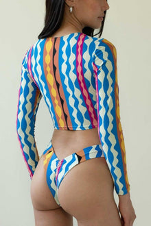 Bikini bottom with multicolored wavy stripe pattern in blue, pink, yellow, and white.