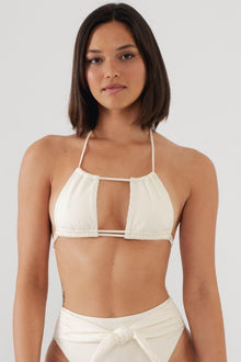 Cream ribbed bikini top with halter neckline, cutout detail, and adjustable straps.